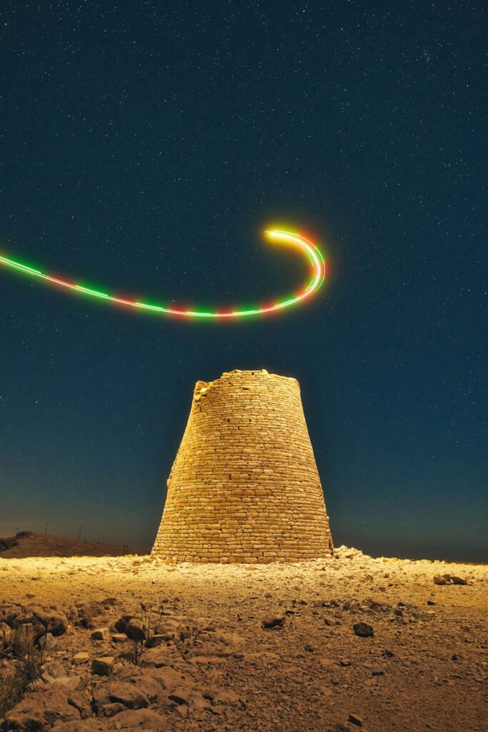 Ancient stone tower under starry night sky